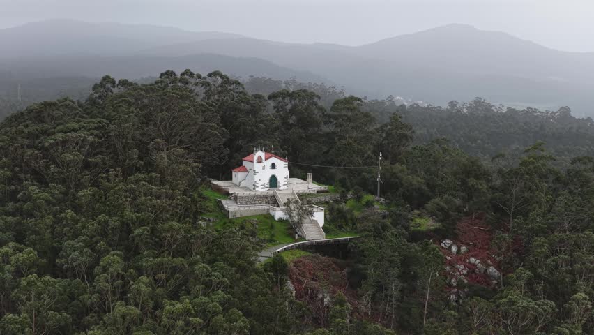 Chapel on top of a mountain drone shot.