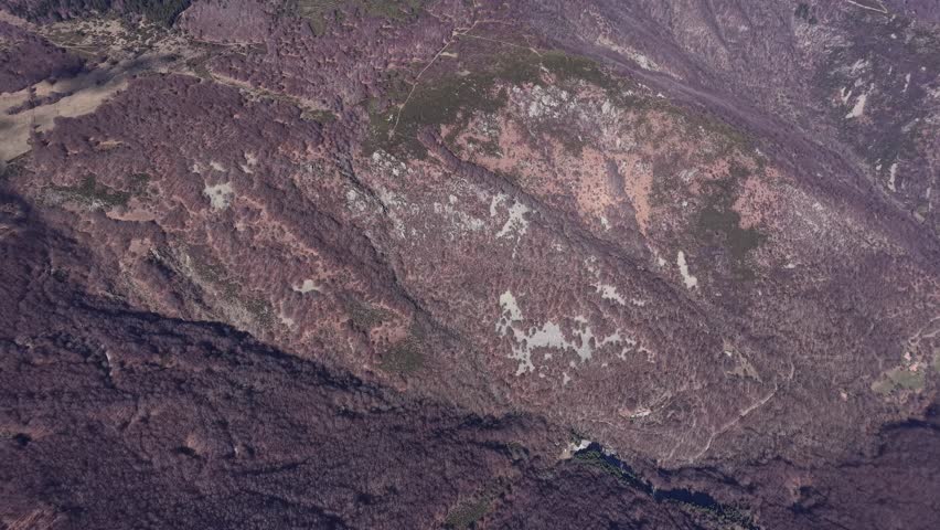 Oblique drone view showing textured rocky slope with sparse vegetation in Montpezat-sous-Bauzon, Ardèche, France