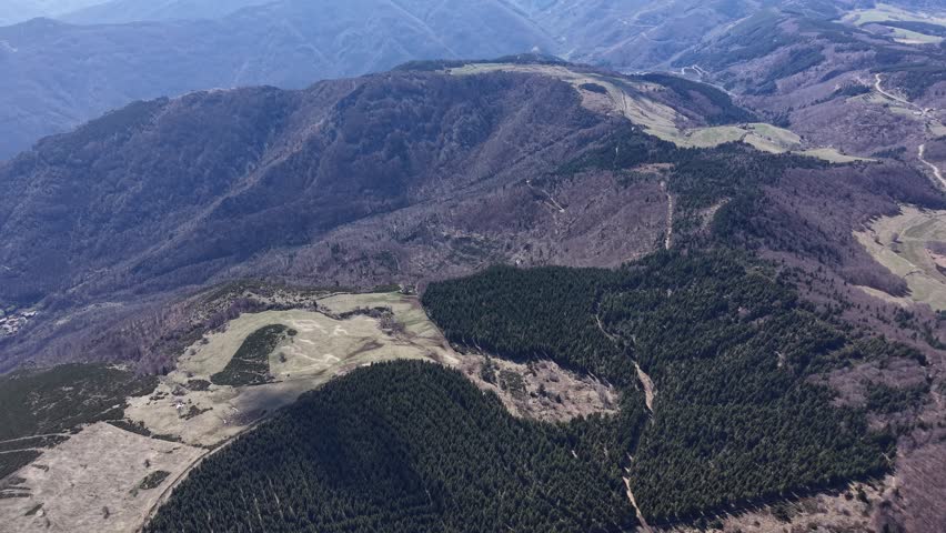 Drone view of sloping terrain combining wooded areas and open clearing in Montpezat-sous-Bauzon, Ardèche, France