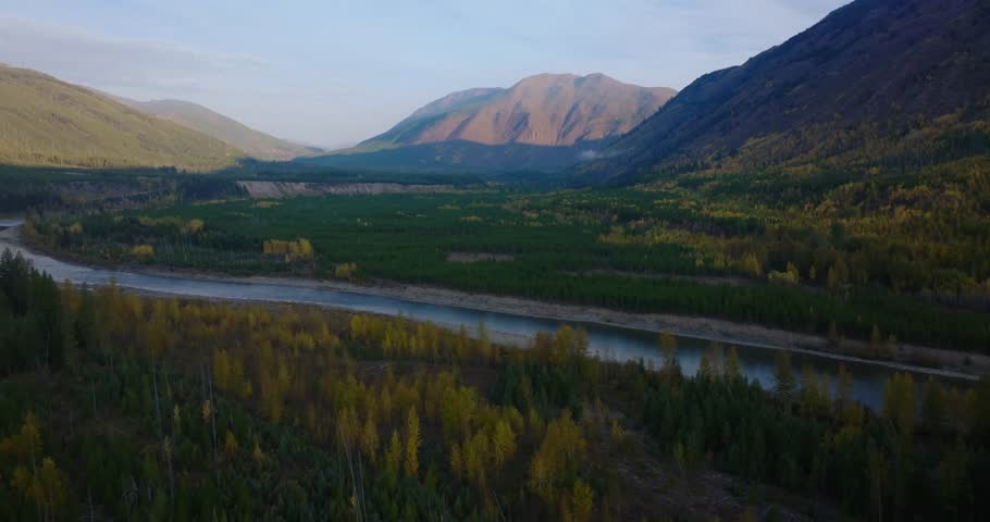 North Fork Flathead River valley with autumn forest and mountains outside Glacier National Park near Polebridge, aerial drone