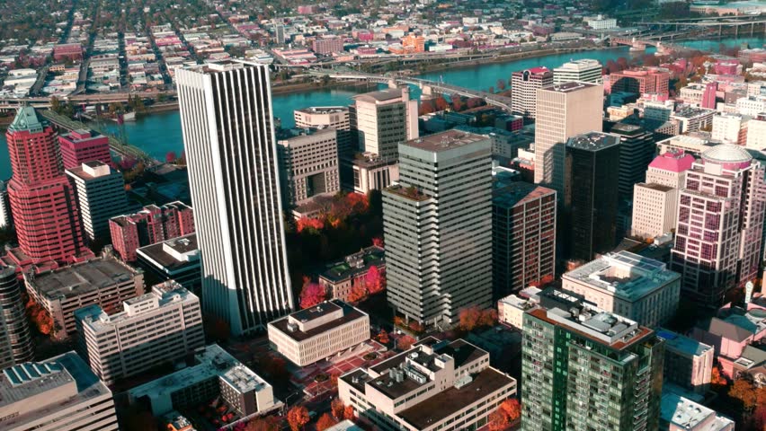 Aerial view of downtown Portland, Oregon featuring PacWest Center, KOIN Tower, bridges and the Willamette River on a clear autumn day in the Pacific Northwest.