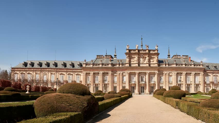 Video of La Granja de San Ildefonso Palace in Segovia, Spain, showing the main facade and formal gardens with symmetrical design and historic Baroque architecture.