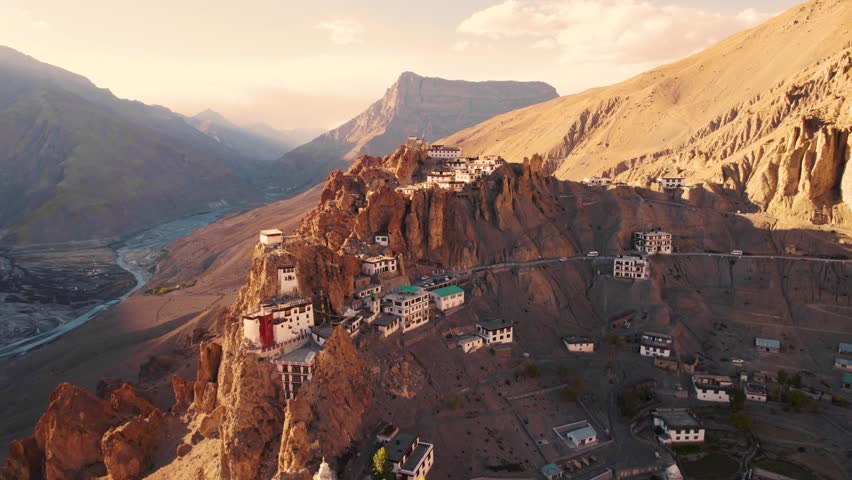 4K Aerial view of mesmerising Dhankar monastery during sunset in Spiti Valley, Himachal Pradesh, India. Ancient Buddhist monastery on cliff and river streams in mountain valley. Travel and holiday concept
