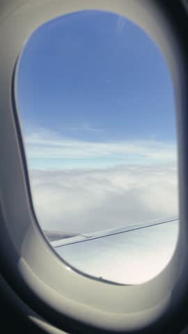 Vertical video from the cabin of a passenger plane, view from the window onto the aircraft