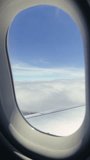 Vertical video from the cabin of a passenger plane, view from the window onto the aircraft's wing The plane enters a cloud zone in a turbulent area. High quality 4k footage - Powered by Shutterstock - Get 15% off with code: PIKWIZARD15