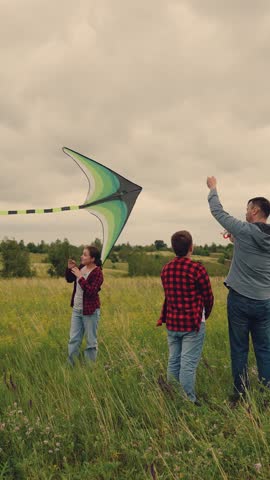 Dad teaches children to fly a kite, open space freedom, kids living out dreams, vibrant kite above, outdoor fun unites family, brother and sister in awe, loving father s presence, creating cherished