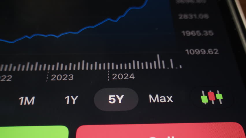 Close up of businessman hand holds phone displaying trading application cash flow stock market, banking realtime cryptocurrency charts, tracking rate market data.