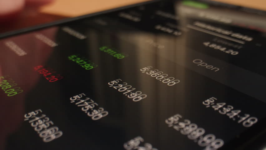 Close up of businessman hand holds phone displaying trading application cash flow stock market, banking realtime cryptocurrency charts, tracking rate market data.