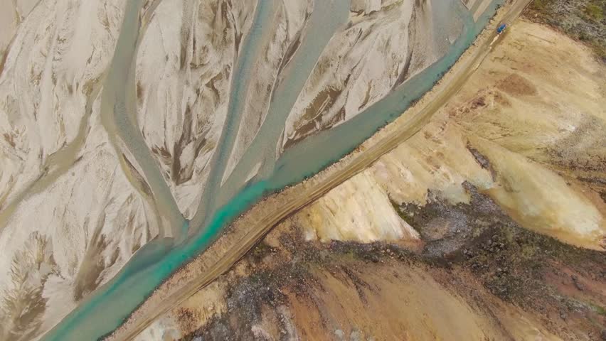 Breathtaking UHD aerial shot of meandering rivers winding through stunning sand formations in a remote landscape. Ideal for nature documentaries and environmental conservation projects.