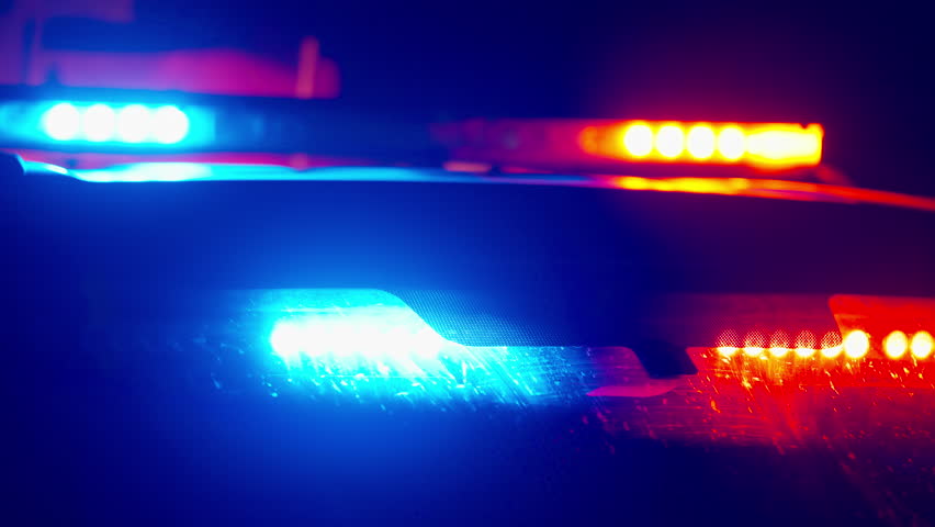 Police emergency lights close up flashing at night with strong blur and glow forming abstract cinematic background and intense urban emergency atmosphere
