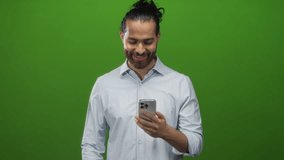 Man tapping smartphone with hand and fingertip in studio against bright green backdrop while checking notifications on his phone; surprise engagement. - Powered by Shutterstock - Get 15% off with code: PIKWIZARD15