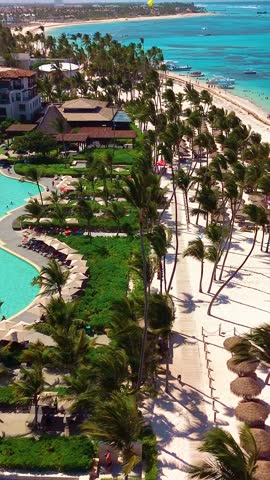 Aerial view of tropical beach, luxury resort with white sand on bright sunny day