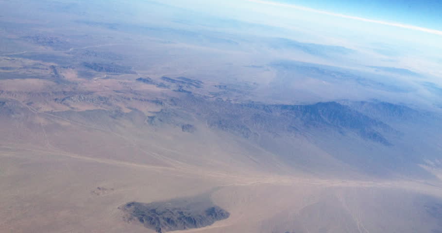 Military combat aircraft cruising fast over desert mountains. War Related 3D Animation.