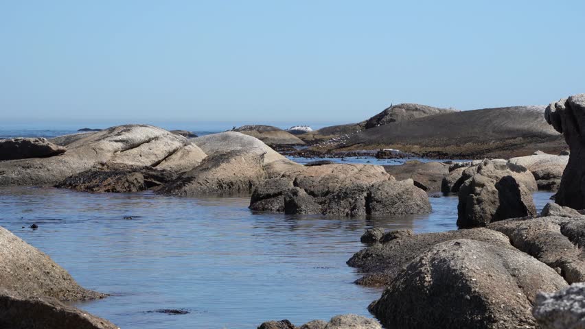 Lots of beach rocks and granite boulders in the sea