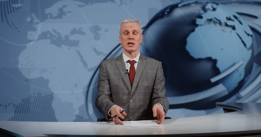 Professional Male Anchor in Grey Checkered Suit and Red Tie Looking at Camera and Gesturing. Concept of Popular Platforms For Discussing Stock Exchange, Market, and Financial News With Experts.