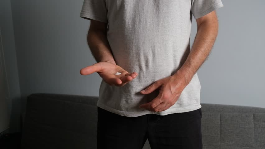 Unrecognizable male rubbing nourishing lotion on his dry skin for skincare and personal hygiene