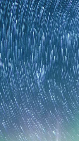 Time lapse capturing the breathtaking Perseid meteor shower with bright meteors streaking across a star filled night sky. Fast luminous trails flash through the darkness, creating a mesmerizing and dynamic celestial display. The natural motion and high contrast between glowing meteors and deep space enhance the sense of scale and wonder, making this footage ideal for astronomy visuals, space themes, documentaries, backgrounds, and creative projects that require a dramatic and captivating cosmic scene.