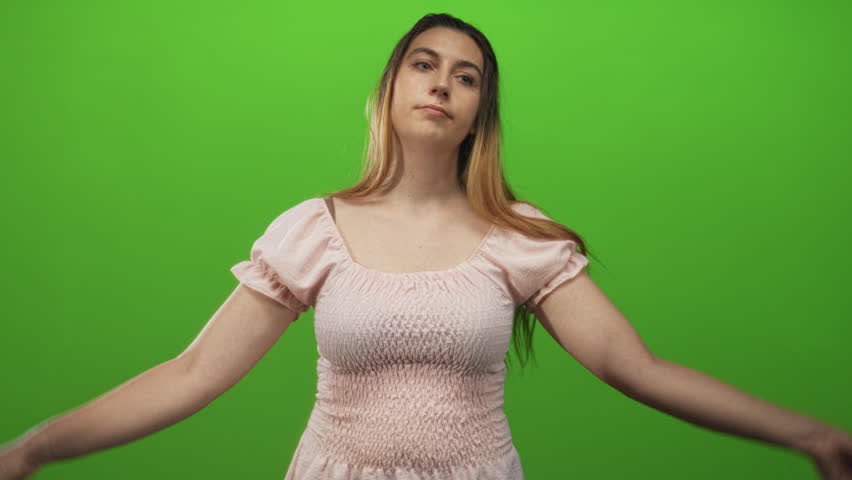 Woman makes air quotes with both hands showing fingers and raised eyebrows in a studio; skepticism irony doubt.