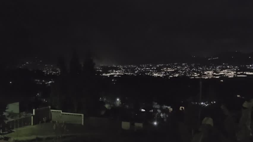 Slow motion video landscape of Pangrango Mountain at night, showing city lights. Panning left to right direction in Full HD (1920x1080) 60fps total 11 secs. 
