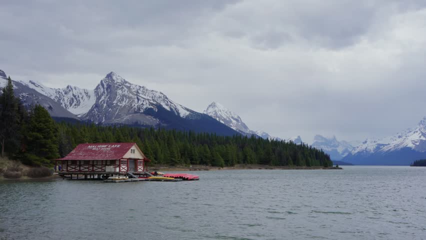 Maligne Lake boat house with snow capped mountains in Jasper National Park, Canada