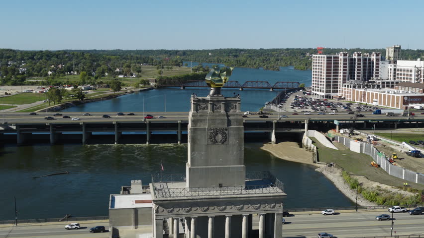 Veterans Memorial Building tower above Cedar River bridges and downtown Cedar Rapids Iowa, aerial dolly zoom vertigo effect