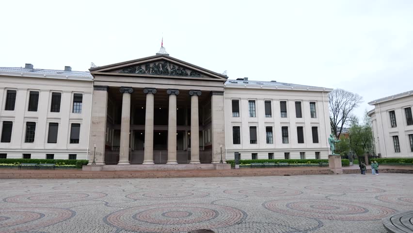 centered symmetrical ground level oslo norway university domus ionic columns reliefs statues stone plaza define scene view of academica