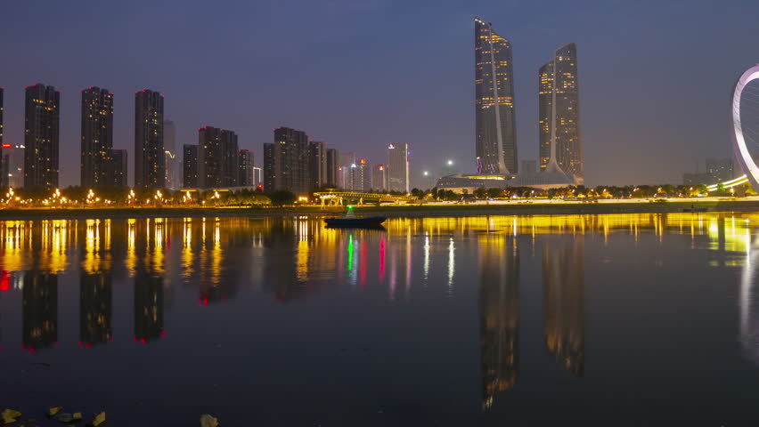 nanjing night illumination famous international youth cultural center riverside pedestrian bridge timelapse panorama 4k china