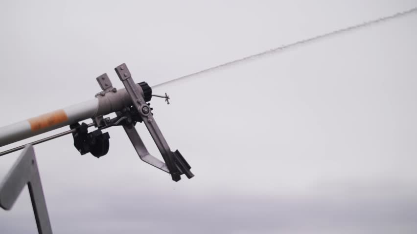 Automatic agricultural sprinkler system spraying water for field irrigation