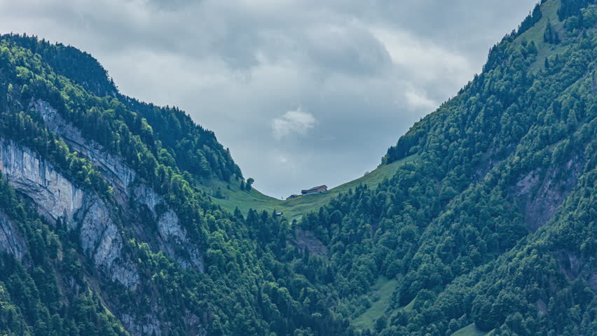 Time lapse, view on a Swiss Alpine farm house high in the mountains. Isenthal, canton Uri, Switzerland. 