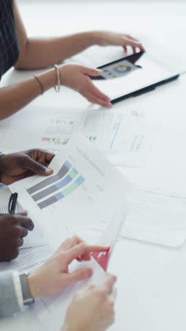 Tablet, documents and hands of business people with graphs for finance report, planning and research. Meeting, office and workers with paperwork, chart and stats for financial projection on screen