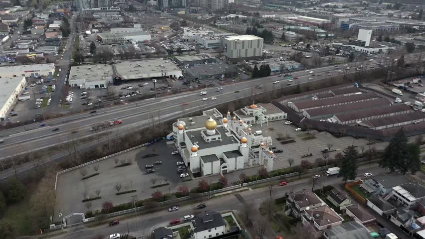 Akali Singh Sikh Society Gurdwara Along Trans-Canada Highway In Vancouver, BC, Canada. aerial pullback, tilt-up shot
