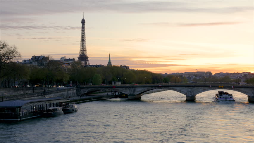 Sunset Time-lapse of Eiffel Tower and Seine River with Tour Boat Passing Under Bridge in Paris