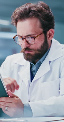 Man, scientist and reading with tablet in lab for research, test results and experiment. Thinking, male person and tech for medical trial, healthcare study and problem solving for vaccine development