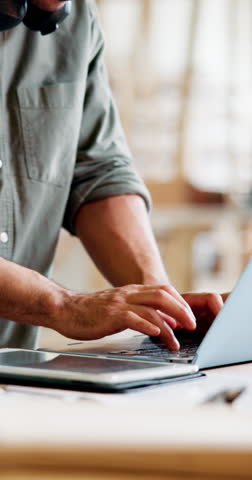 Carpenter, laptop and man in factory, typing and email for online order, internet and manufacturing. Person, business owner and employee in workshop, computer and stock update for timber logistics