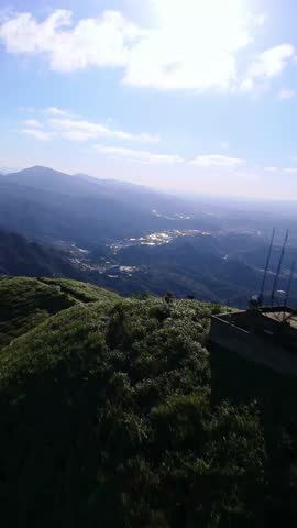 A vertical FPV drone flies smoothly over mountains in Taiwan featuring scenic hiking trails