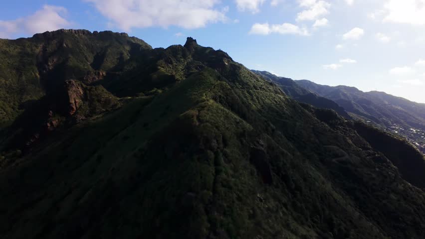 Aerial view FPV drone flies smoothly over mountains in the sea off Taiwan