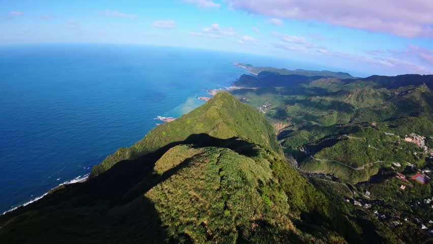 aerial view FPV drone flies smoothly over mountains heading towards the Taiwan Sea