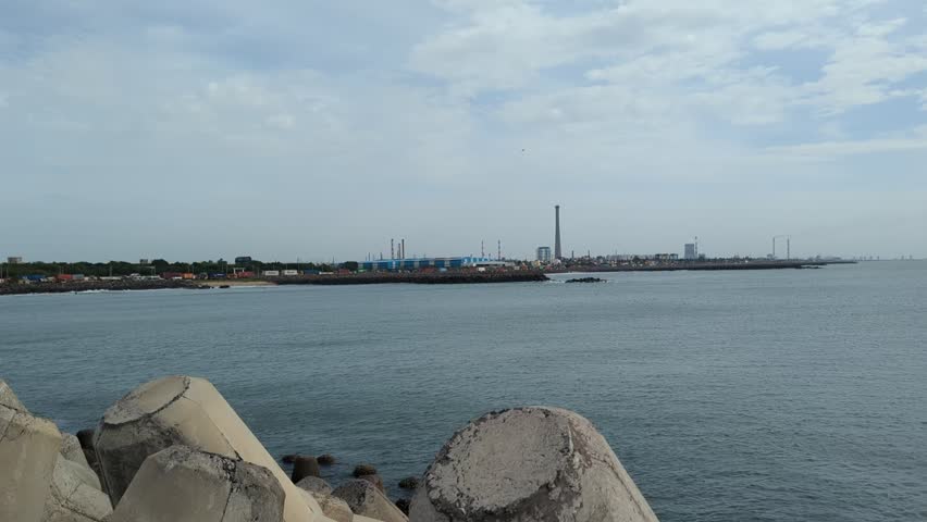 Scenic coastal video footage of sea and ocean waves at Marina Beach Chennai India with fishing boats and rocky shoreline
