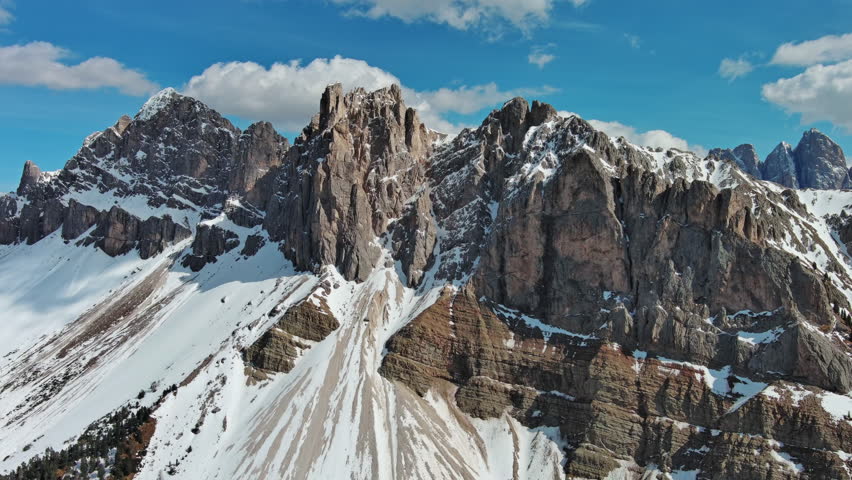 Aerial view of majestic rocky mountains in snow Alps, Dolomites, Italy, 4k