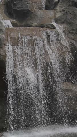 Water cascade from small waterfall, dynamic motion of falling water creates natural visual effect in slow motion.