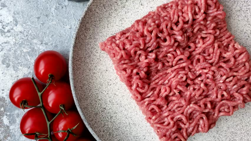 Raw ground beef for a burger or as an ingredient in a meat dish. Raw ground beef as a food background for your design