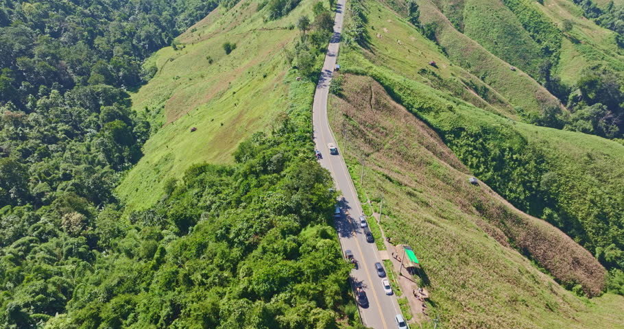 Aerial drone view of Nan’s famous sky road built along a mountain ridge, surrounded by layered peaks and dramatic natural landscape, a popular travel and photography destination in Thailand.