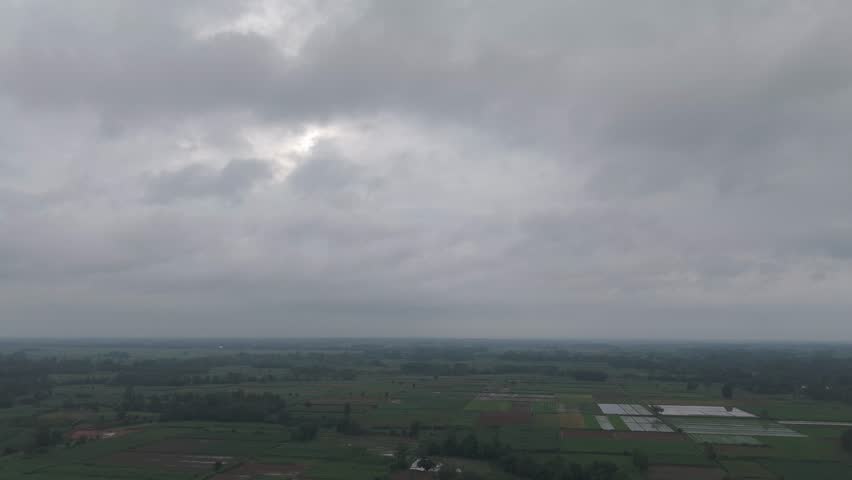 A wide view of green landscape under overcast sky