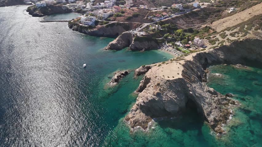 Beautiful aerial view of a seaside village and rocky coast in crete, greece, on a sunny day