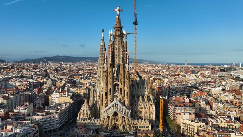 Establishing aerial shot of Barcelona city skyline with famous tourist landmark Sagrada Familia, historic Barcelona cathedral. Catalonia, Spain