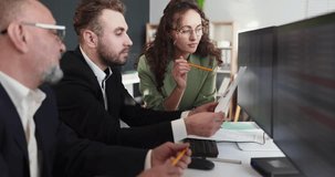 Accountants analysts team review finance report charts. Colleagues discuss data at computer screens in office, planning budgets and tax compliance. Clear concept of office finance teamwork. - Powered by Shutterstock - Get 15% off with code: PIKWIZARD15