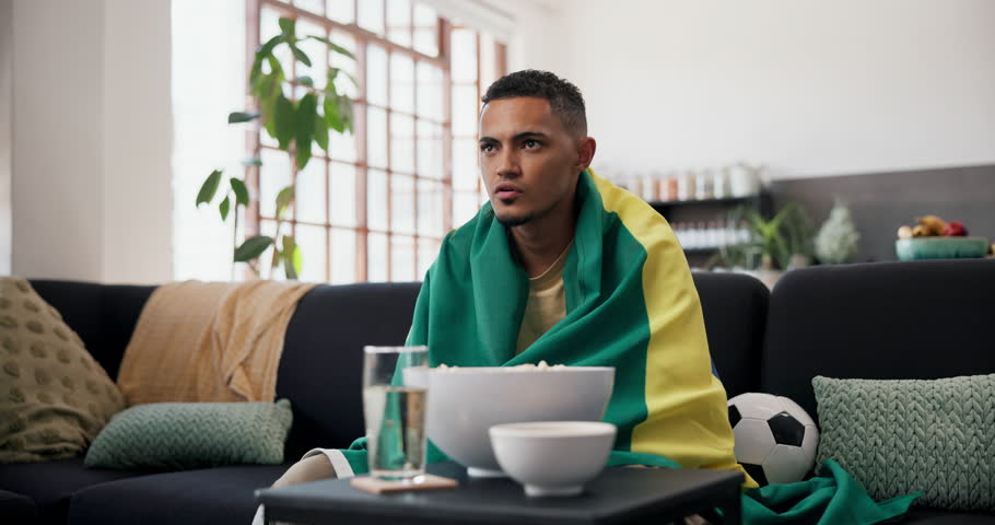 Celebrate, Brazil flag or happy man watching tv on couch, sports competition or excited for soccer game win. Live stream, football fan or cheering for tournament match success, player goal or home