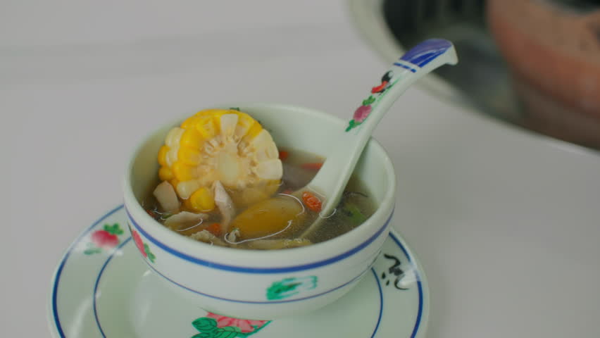 Close-up of hot pot soup poured into a plate. Asian corn soup is delicious.
