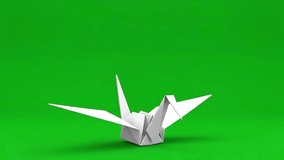 A delicate white origami crane bird appears to float gracefully against a vibrant green background, symbolizing peace and hope. - Powered by Shutterstock - Get 15% off with code: PIKWIZARD15