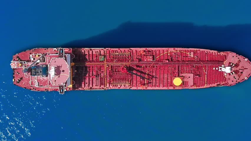 An oil tanker navigates open seas, laden with crude oil essential for global energy needs. Witness the role of maritime logistics in fueling economies.